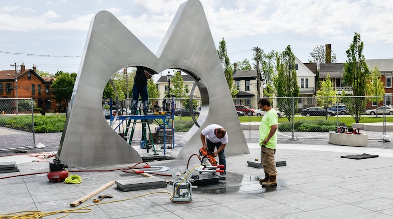 Workers were installing a new sculpture in Hamilton’s Marcum Park this past week. The fountain should begin flowing May 12 during the Hamilton Flea event. NICK GRAHAM/STAFF