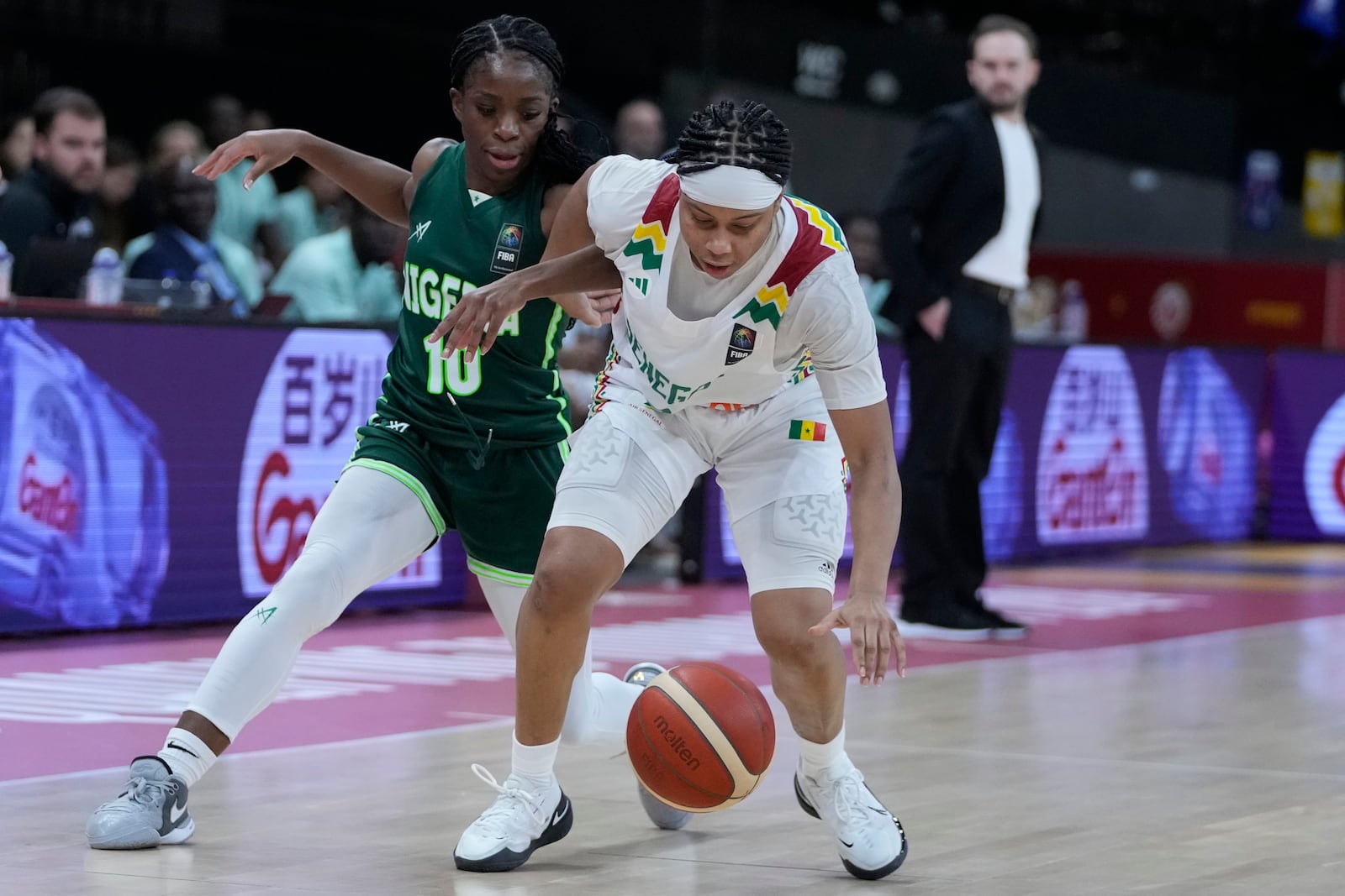 FILE - Senegal's Cierra Dillard, right, and Nigeria's Promise Amukamara chase a loose ball during a Women's Olympic Qualifying group A basketball match in Antwerp, Belgium, on Feb. 8, 2024. (AP Photo/Virginia Mayo, File)