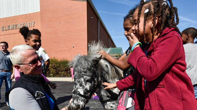 Lisa Moad, with Seven Oaks Farm, shows off a miniature horse named Patches during an anti-bullying program at Riverview Elementary School Friday, Oct. 20, 2017 in Hamilton. NICK GRAHAM/STAFF