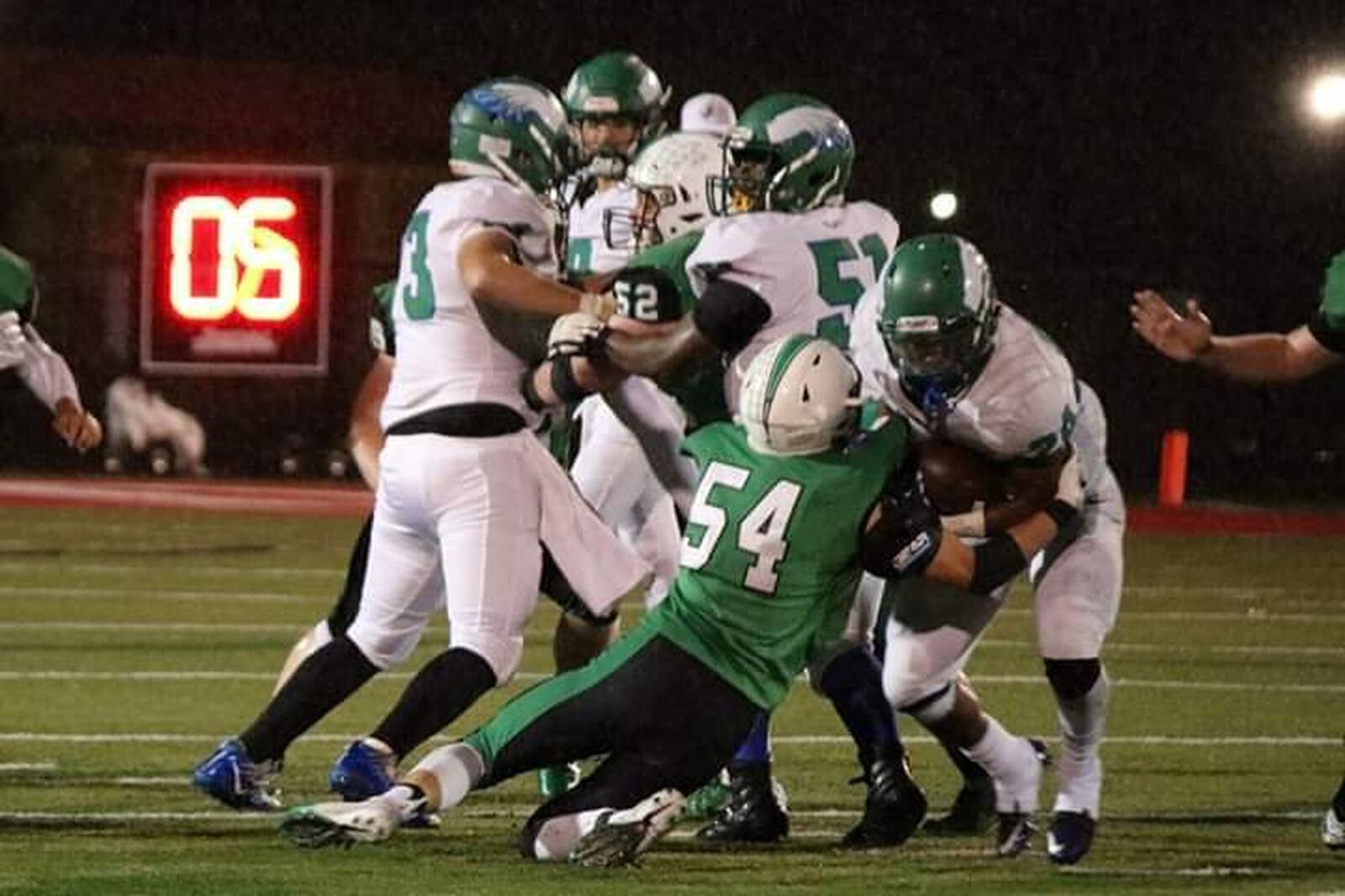 Badin’s Evan Schlensker (54) gets a grip on Chaminade Julienne running back Quincy Johnson (24) during Friday night’s game at Fairfield Stadium in Fairfield. Badin posted a 38-21 victory. CONTRIBUTED PHOTO BY TERRI ADAMS