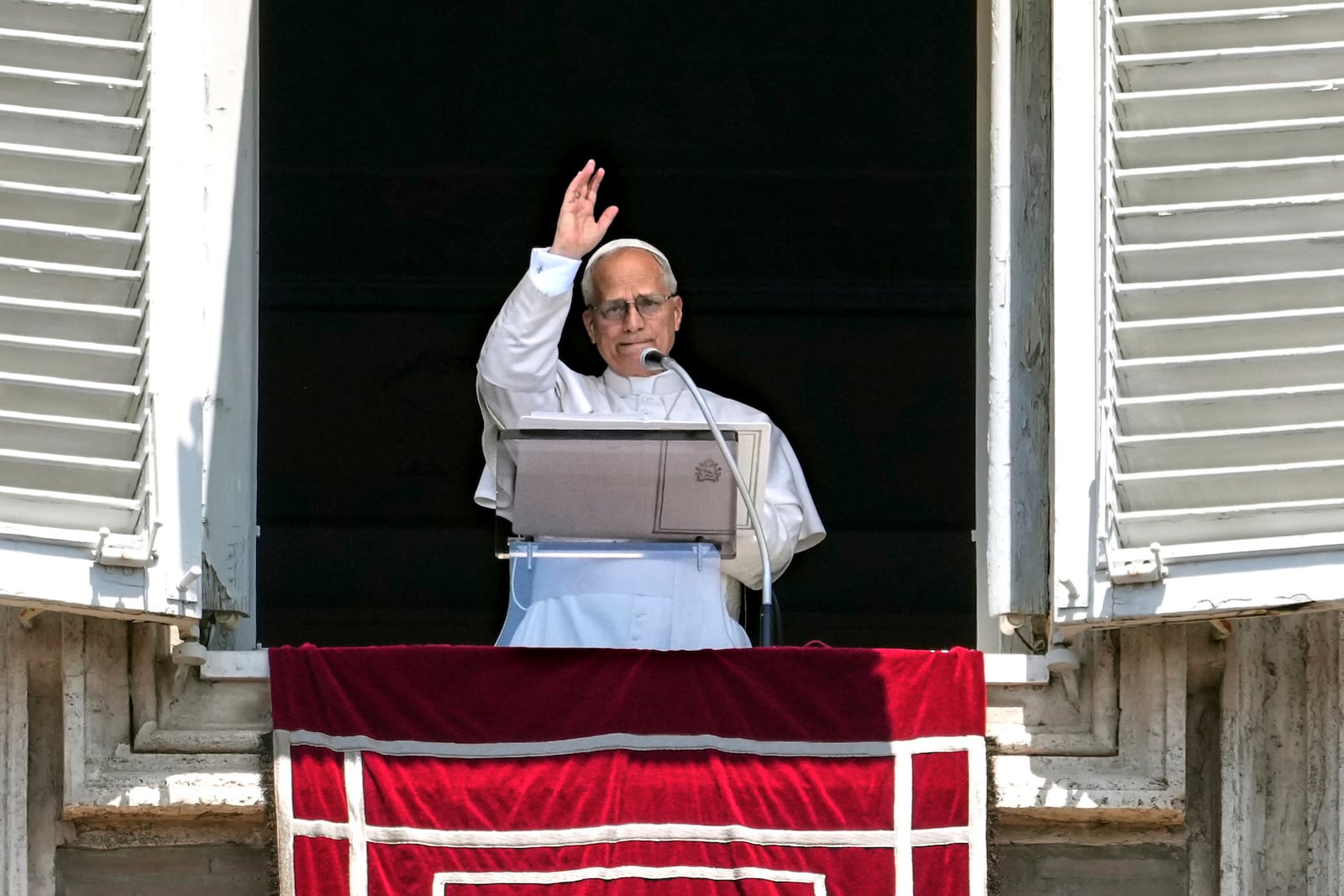 Pope Leo XIV appears at his studio's window to bless the faithful gathered in St. Peter's Square at the Vatican for the Angelus prayer, Sunday. (AP Photo/Andrew Medichini)