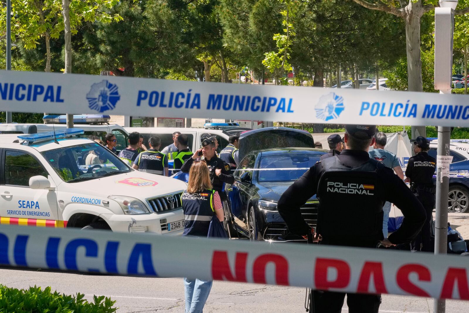 Police officers cordon off the area after an adviser to former Ukrainian president Viktor Yanukovych was shot, outside a school in Madrid, Spain, Wednesday, May 21, 2025. (AP Photo/Paul White)