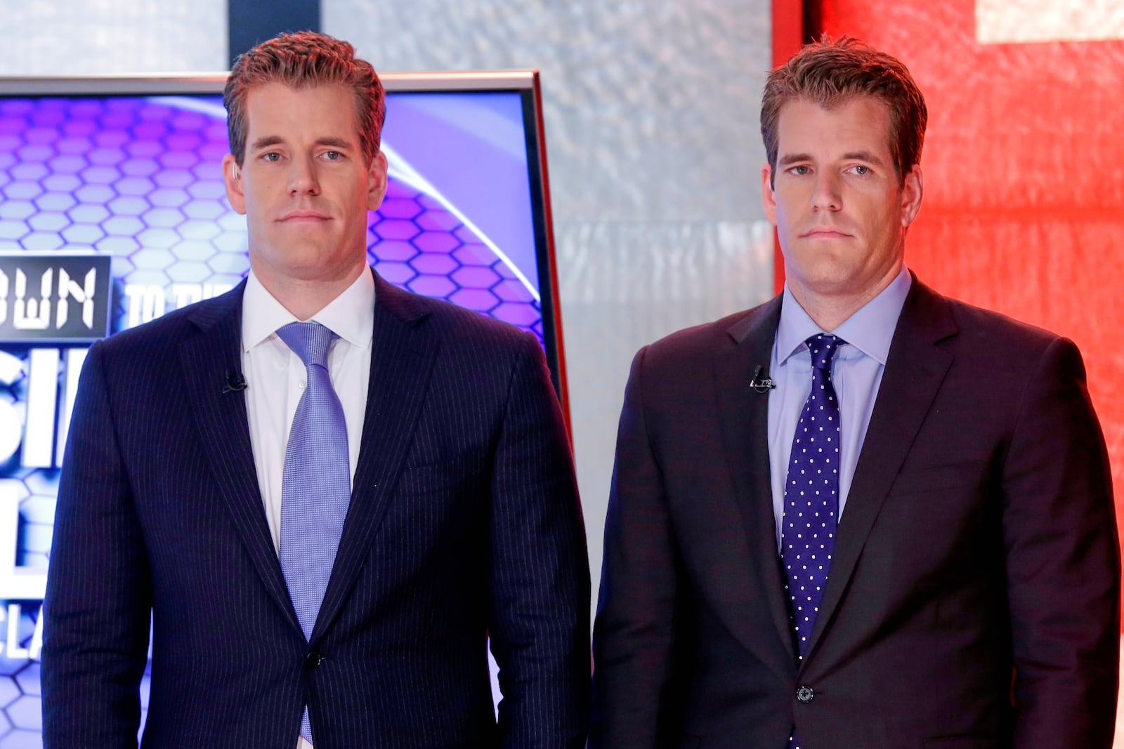 FILE - Cameron Winklevoss, left, and Tyler Winklevoss, founders of Gemini Trust Co., wait to appear on the "Countdown to the Closing Bell with Liz Claman" program, on the Fox Business Network, in New York, Oct. 8, 2015. (AP Photo/Richard Drew, File)
