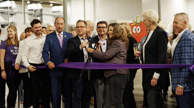 80 Acres Farms, headquartered in Hamilton, Ohio, held a ribbon-cutting ceremony on Sept. 13, 2023, at its new farm in Florence, Ky. The farm will help expand the indoor farming business its reach to around 1,000 Kroger locations and expand its offerings with new salad kits. PROVIDED/80 ACRES FARMS