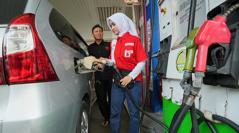 An employee fills up the fuel tank of a car at a gas station in Jakarta, Indonesia, Tuesday, March 3, 2026. (AP Photo/Achmad Ibrahim)