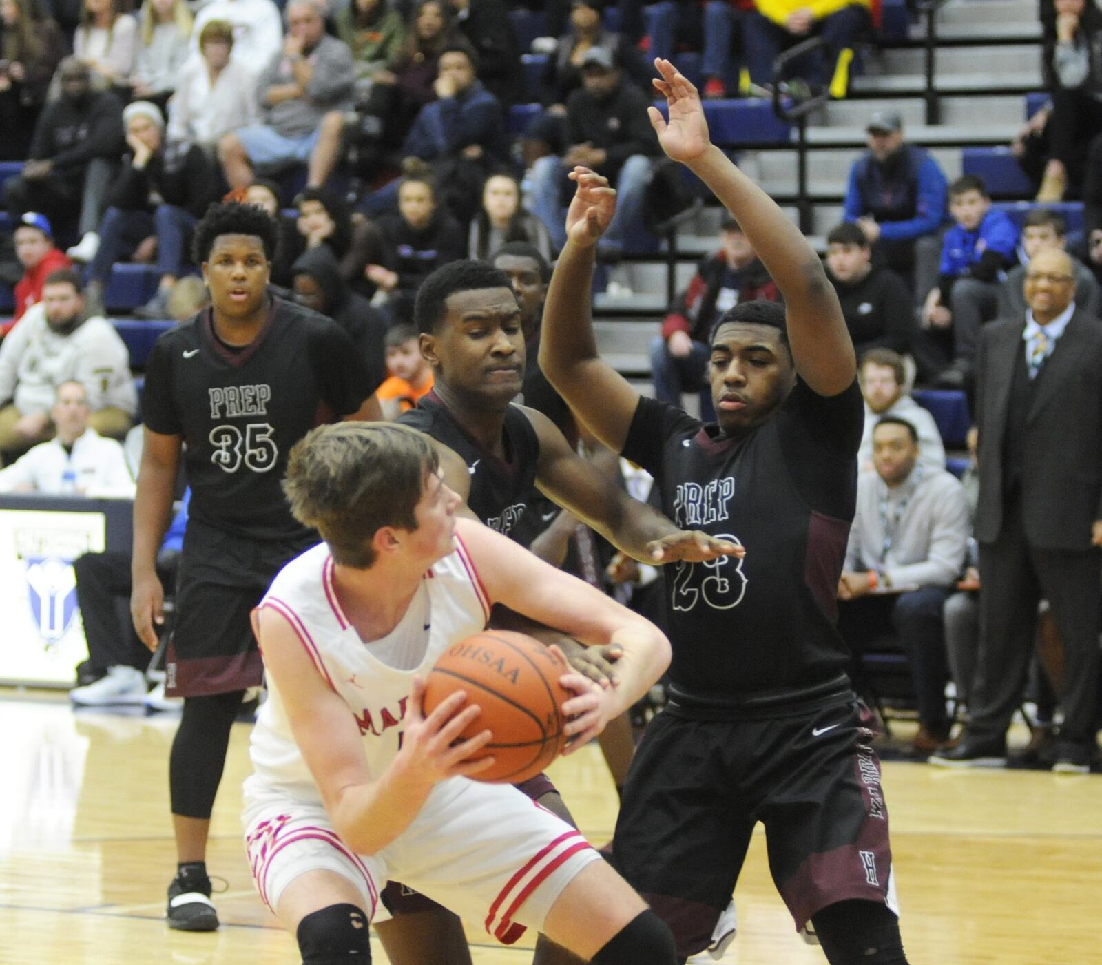 Madison’s Grant Whisman is cut off by two Canal Winchester Harvest Prep defenders, including Avonti Duncan (23), during Flyin’ to the Hoop on Monday night at Fairmont’s Trent Arena. Harvest Prep won 79-56. MARC PENDLETON/STAFF