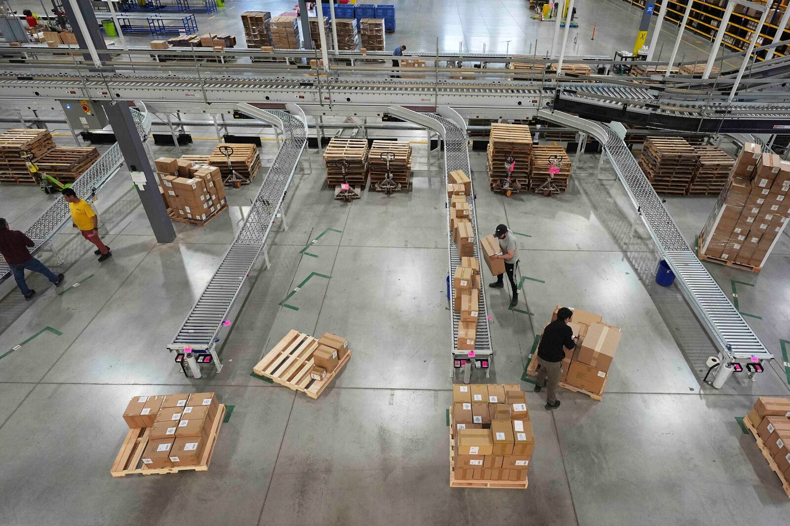 Employees of Learning Resources, an educational toy company, work at a warehouse in Vernon Hills, Ill., Friday, April 11, 2025. (AP Photo/Nam Y. Huh)