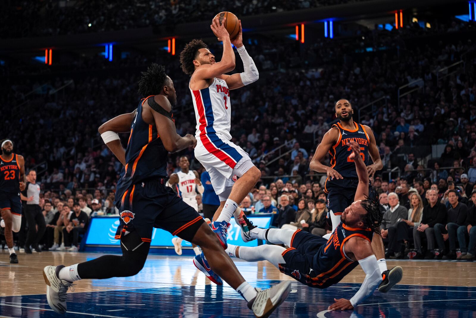 Detroit Pistons guard Cade Cunningham (2) scores and knocks down New York Knicks guard Jalen Brunson (11) during the first half of Game 2 of an NBA basketball first-round playoff series, Monday, April 21, 2025, in New York. (AP Photo/Angelina Katsanis)