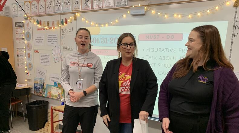 Leigh Terry of Central Elementary just found out she was one of 10 finalists in southwest Ohio and Northern Kentucky for the annual Gold Star and The Children’s Theatre of Cincinnati top teacher contest. The prestigious award, which includes a $2,000 grant for the winner’s classroom, yearly recognizes the region’s best educators. At left is Terry in her classroom with officials from Gold Star and The Children's Theater of Cincinnati. (Provided)
