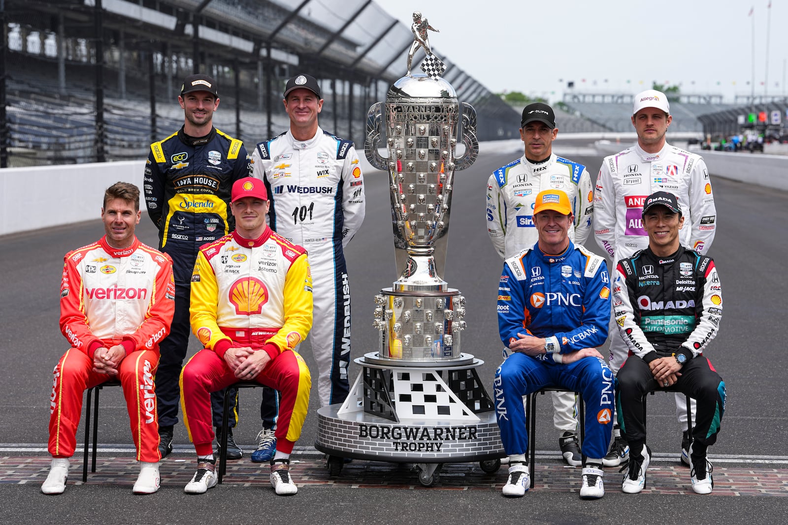 The former winners of the Indianapolis 500, top row, left to right, Alexander Rossi, Ryan Hunter-Reay, Helio Castroneves, of Brazil, and Marcus Ericsson, of Sweden, bottom bottom row, Will Power, of Australia, Josef Newgarden, Scott Dixon, of New Zealand, and Takuma Sato, of Japan, pose for a photo on the start/finish line before practice for the Indianapolis 500 auto race at the Indianapolis Motor Speedway in Indianapolis, Monday, May 19, 2025. (AP Photo/Michael Conroy)