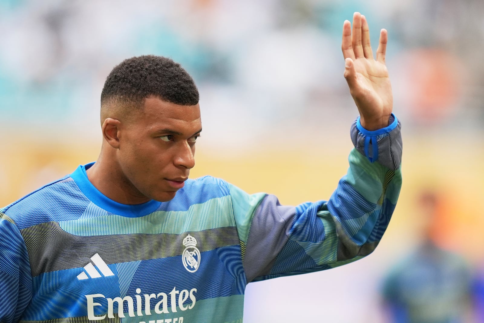 Real Madrid's Kylian Mbappe waves during a warmup for the Club World Cup round of 16 soccer match between Real Madrid and Juventus in Miami Gardens, Fla., Tuesday, July 1, 2025. (AP Photo/Rebecca Blackwell)