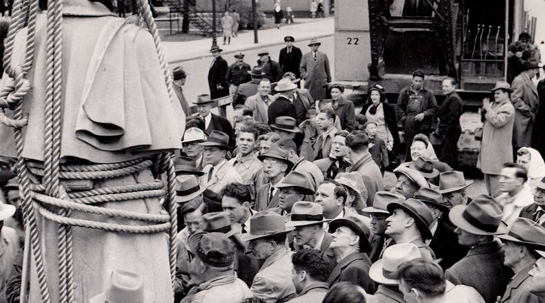 The Civil War Soldiers Monument was relocated in 1948. “As it reached the ground, the 9 1/2 ft. statue was literally mobbed,” reported the Dayton Daily News. “The intersection of Main Street and Monument Avenue was one mass of people, all striving to get in close for a look or a picture.” DAYTON DAILY NEWS ARCHIVE