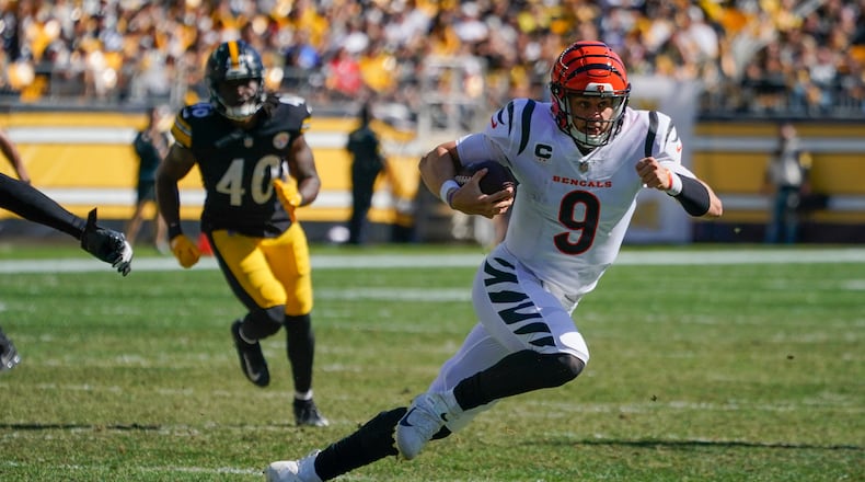 Cincinnati Bengals quarterback Joe Burrow (9) scrambles for a first down against the Pittsburgh Steelers during the second half an NFL football game, Sunday, Sept. 26, 2021, in Pittsburgh. (AP Photo/Gene J. Puskar)
