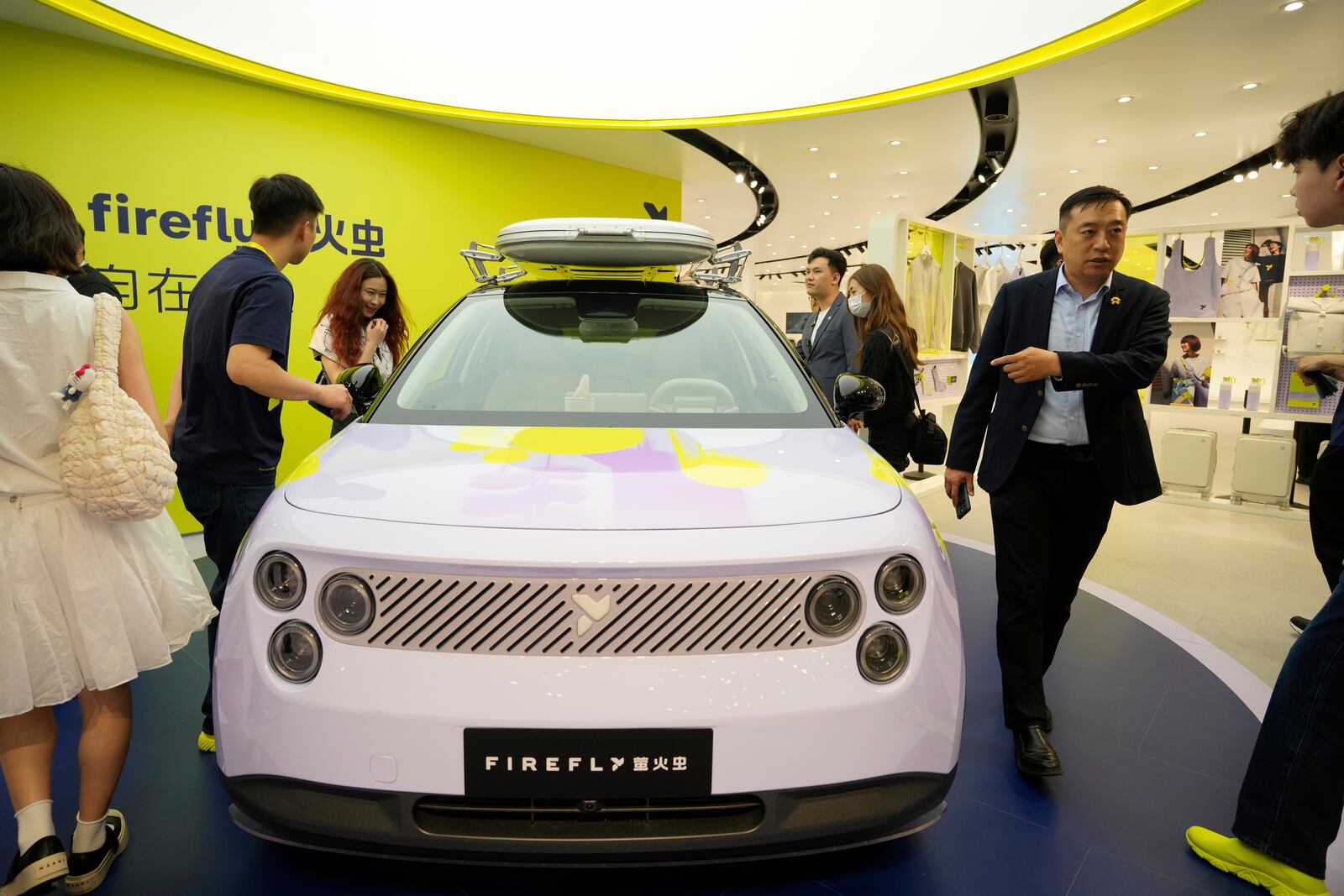 Visitors look at the new Firefly model from Chinese automaker Nio during the Shanghai auto show on Wednesday, April 23, 2025. (AP Photo/Ng Han Guan)