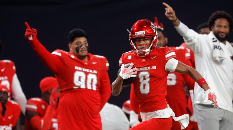 UNLV wide receiver Taeshaun Lyons (8) runs down the UNLV sideline for a touchdown after a pass reception during the first half of an NCAA college football game against Hawaii Friday, Nov. 21, 2025, in Las Vegas. (Steve Marcus/Las Vegas Sun via AP)