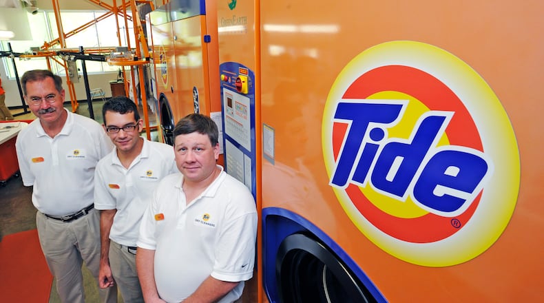 Tide Dry cleaners opened in Liberty Twp. on July 27. It is Tide’s first franchise location owned by former P&G employee Ray D’Alonzo (left). D’Alonzo stands with his son, Dominic, and his son-in-law Rick DeAngelis, who will help him run the store.