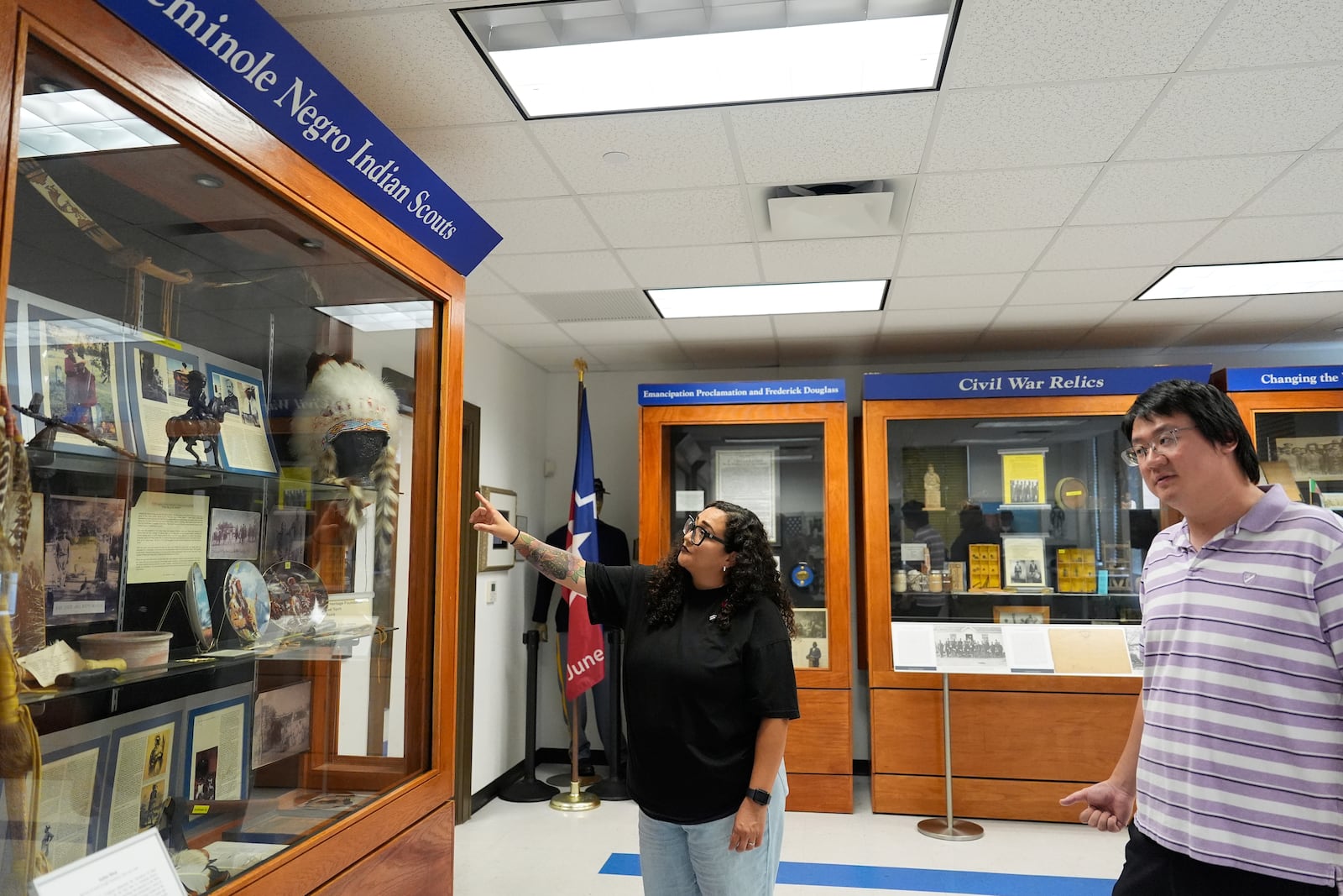 Director of Education Dr. Michelle Tovar, center, and archivist Jason Fung describe how current displays will be redone inside the Buffalo Soldiers National Museum on Friday, June 27, 2025, in Houston, Texas. (AP Photo/Ashley Landis)