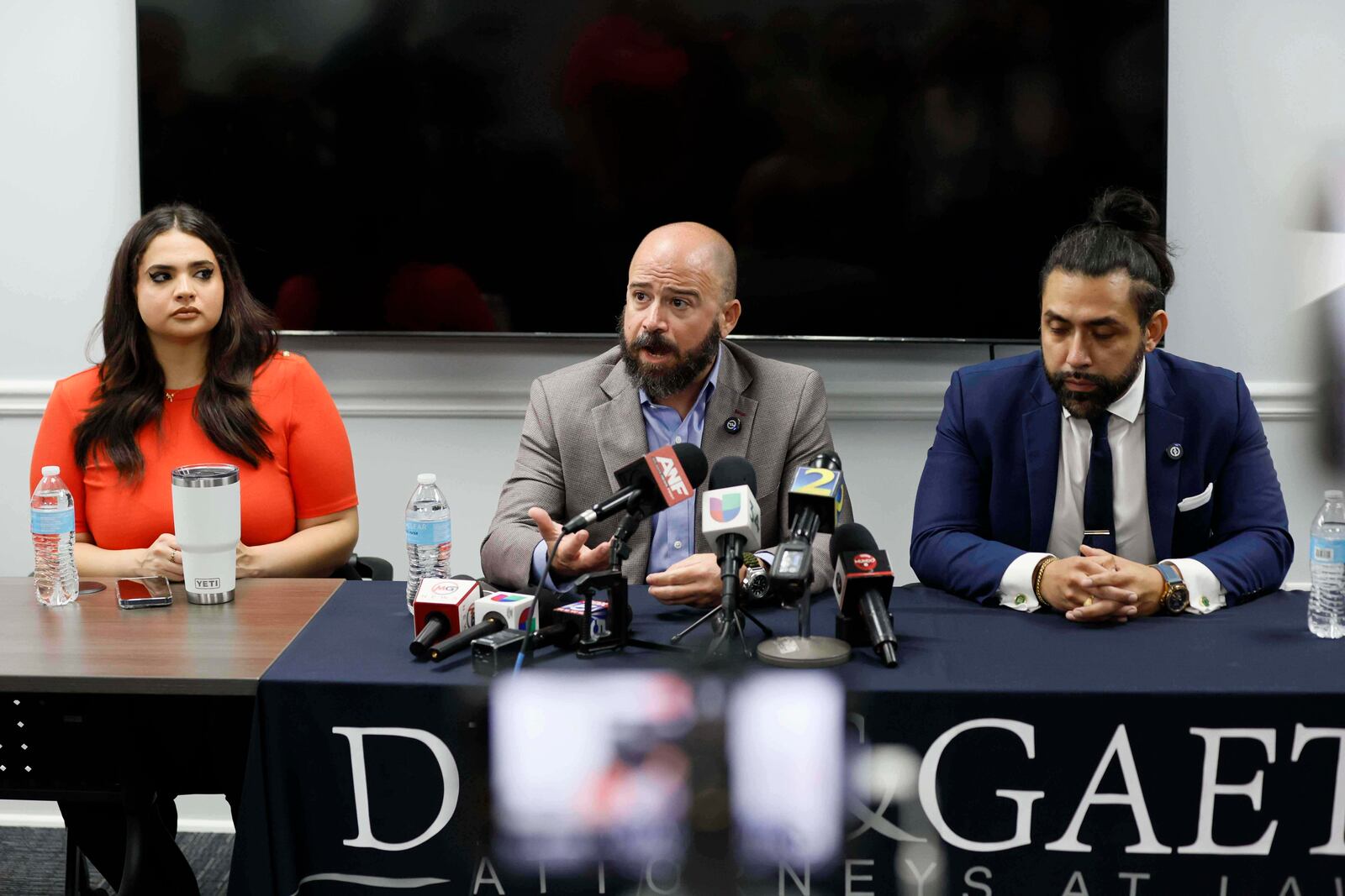 Giovanni Diaz, center, alongside Zacharias Gaeta and Katherine Guevara, speaks during a press conference about the status of Mario Guevara, a metro Atlanta-based Spanish-language reporter from MGNews, addressing his situation following his arrest while covering an immigration rally, Tuesday, June 17, 2025, in Smyrna, Ga. (Miguel Martinez/Atlanta Journal-Constitution via AP)