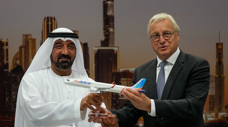 Airbus' CEO of commercial aircraft Christian Scherer presents a model of Airbus A321neo aircraft to Sheikh Ahmed bin Saeed Al Maktoum, the chairman and chief executive of Emirates and chairman of FlyDubai at a press conference to announce an order for 150 Airbus A321neo aircraft at the Dubai Air Show, United Arab Emirates, Tuesday, Nov. 18, 2025. (AP Photo/Altaf Qadri)