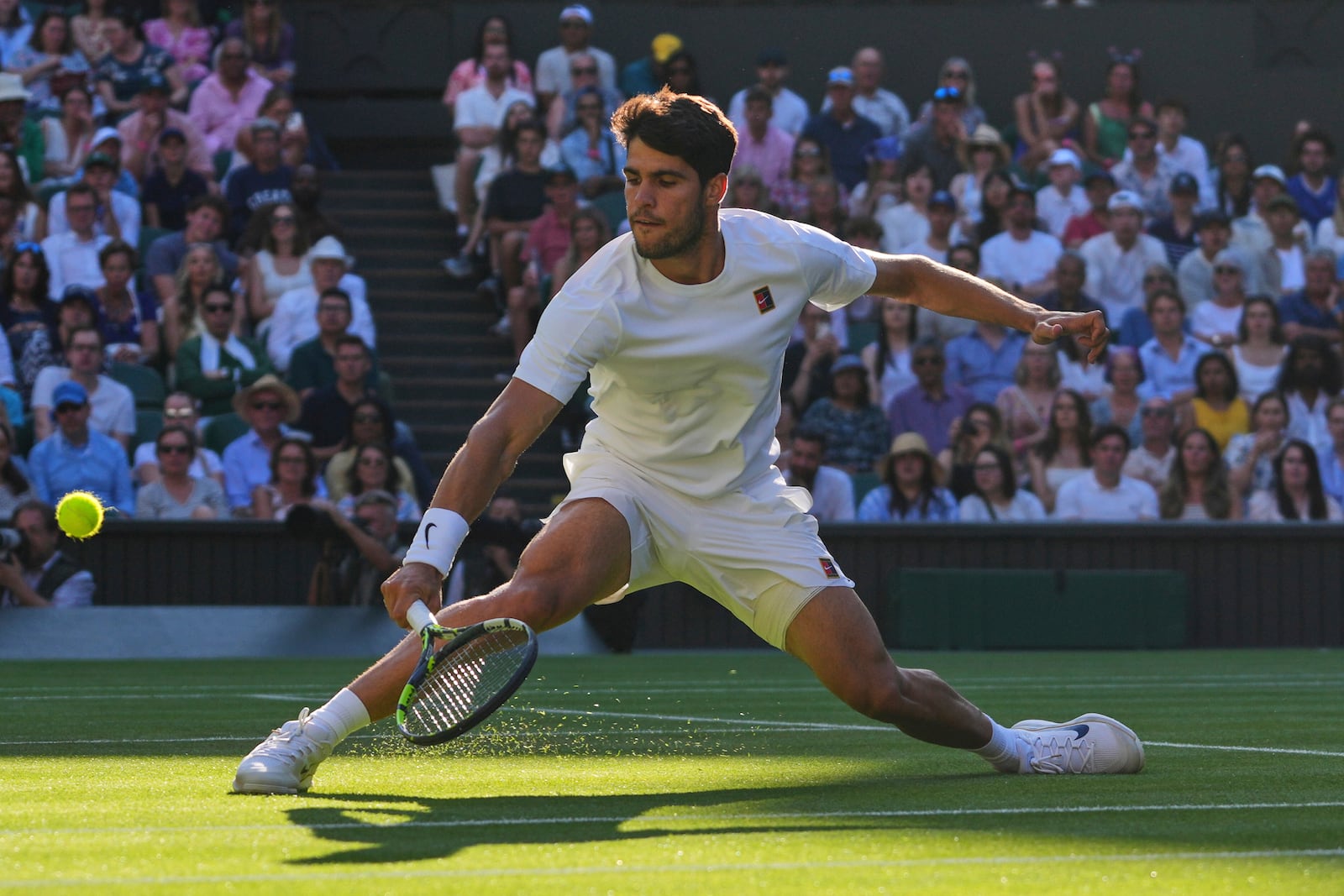 Spain's Carlos Alcaraz returns to Britain's Cameron Norrie during a quarterfinal men's singles match at the Wimbledon Tennis Championships in London, Tuesday, July 8, 2025. (AP Photo/Kirsty Wigglesworth)