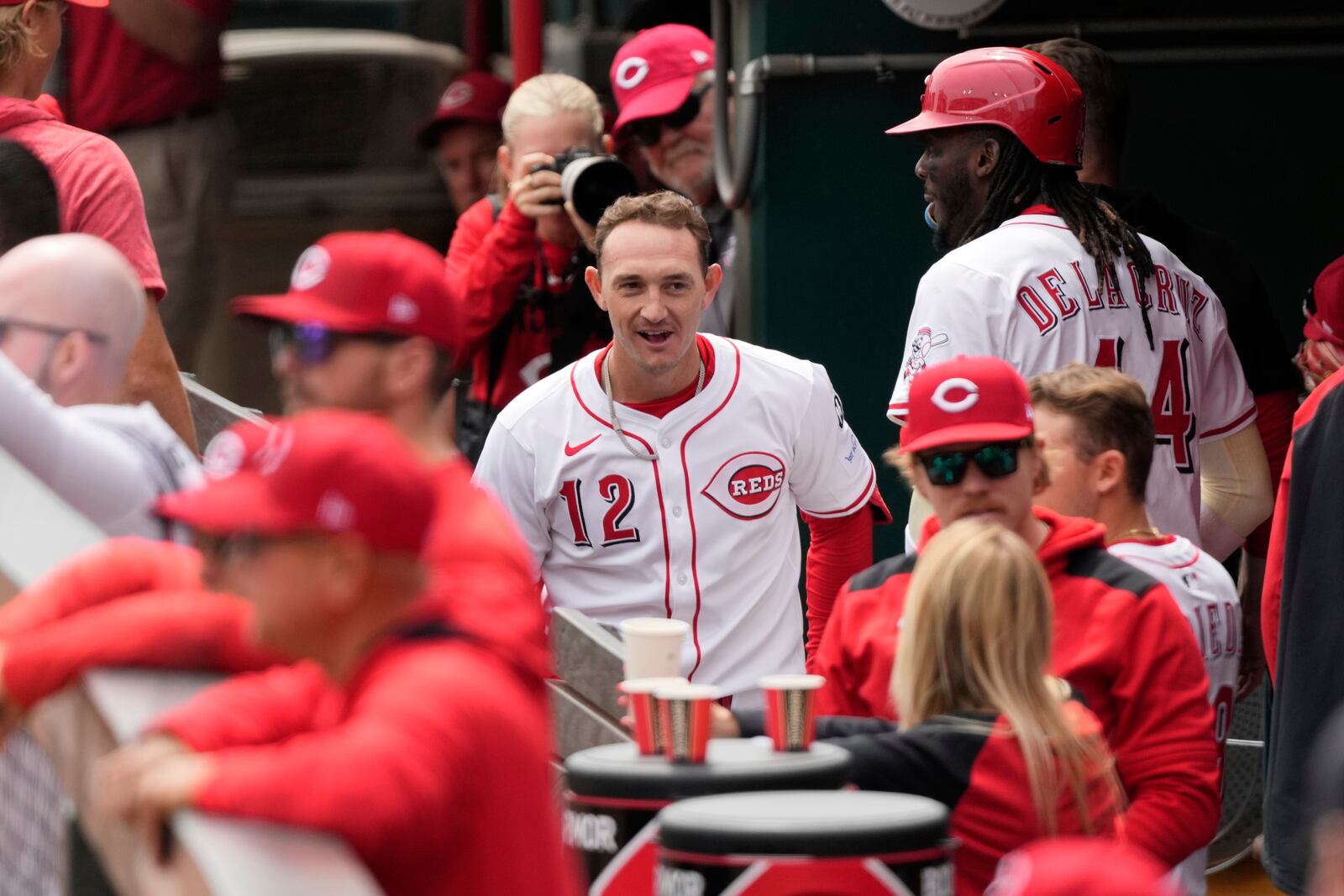 Cincinnati Reds Austin Hays, left, and Elly De La Cruz, right, celebrate Hays' two-run homer in the dugout in the first inning of a baseball game against the Seattle Mariners, Thursday, April 17, 2025, in Cincinnati. (AP Photo/Carolyn Kaster)