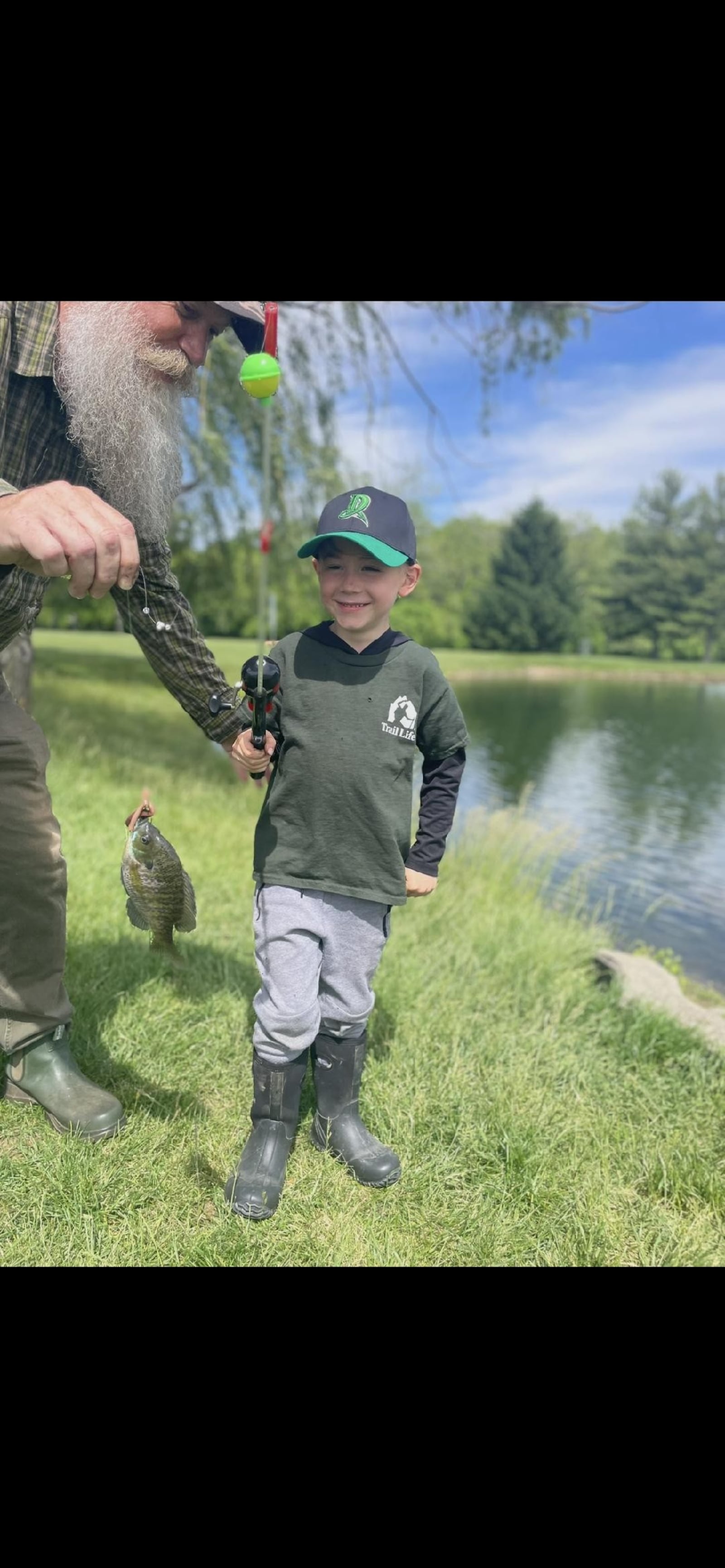 Kirk Wilson catching a fish with his dad, Nick. Kirk likes to keep the bait as pets. CONTRIBUTED