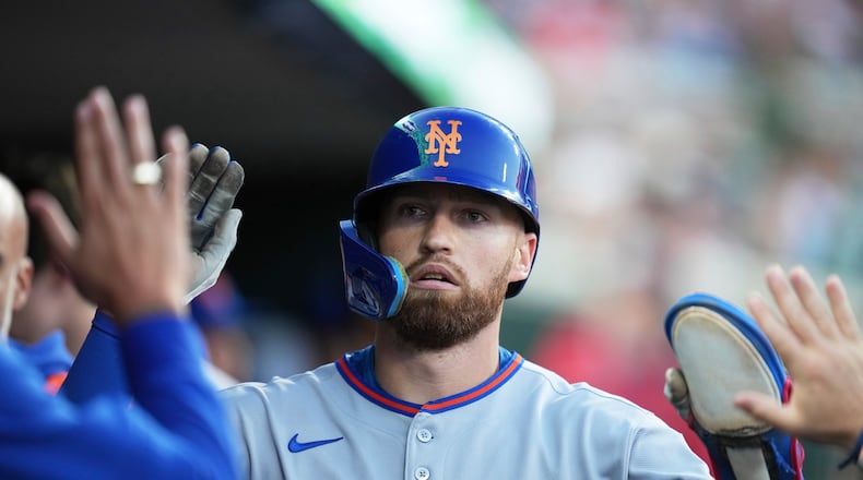 FILE - New York Mets' Brandon Nimmo celebrates in the dugout after scoring off of a sacrifice fly by Cedric Mullins during the fourth inning of a baseball game against the Detroit Tigers, Tuesday, Sept. 2, 2025, in Detroit. (AP Photo/Ryan Sun, File)