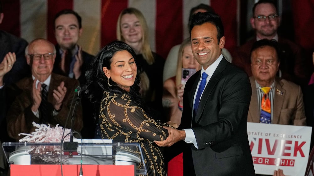 Apoorva Ramaswamy, left, greets her husband, Vivek Ramaswamy, right, a Republican candidate for governor of Ohio, at a rally Wednesday, Jan. 7, 2026, in Cleveland. (AP Photo/Sue Ogrocki)