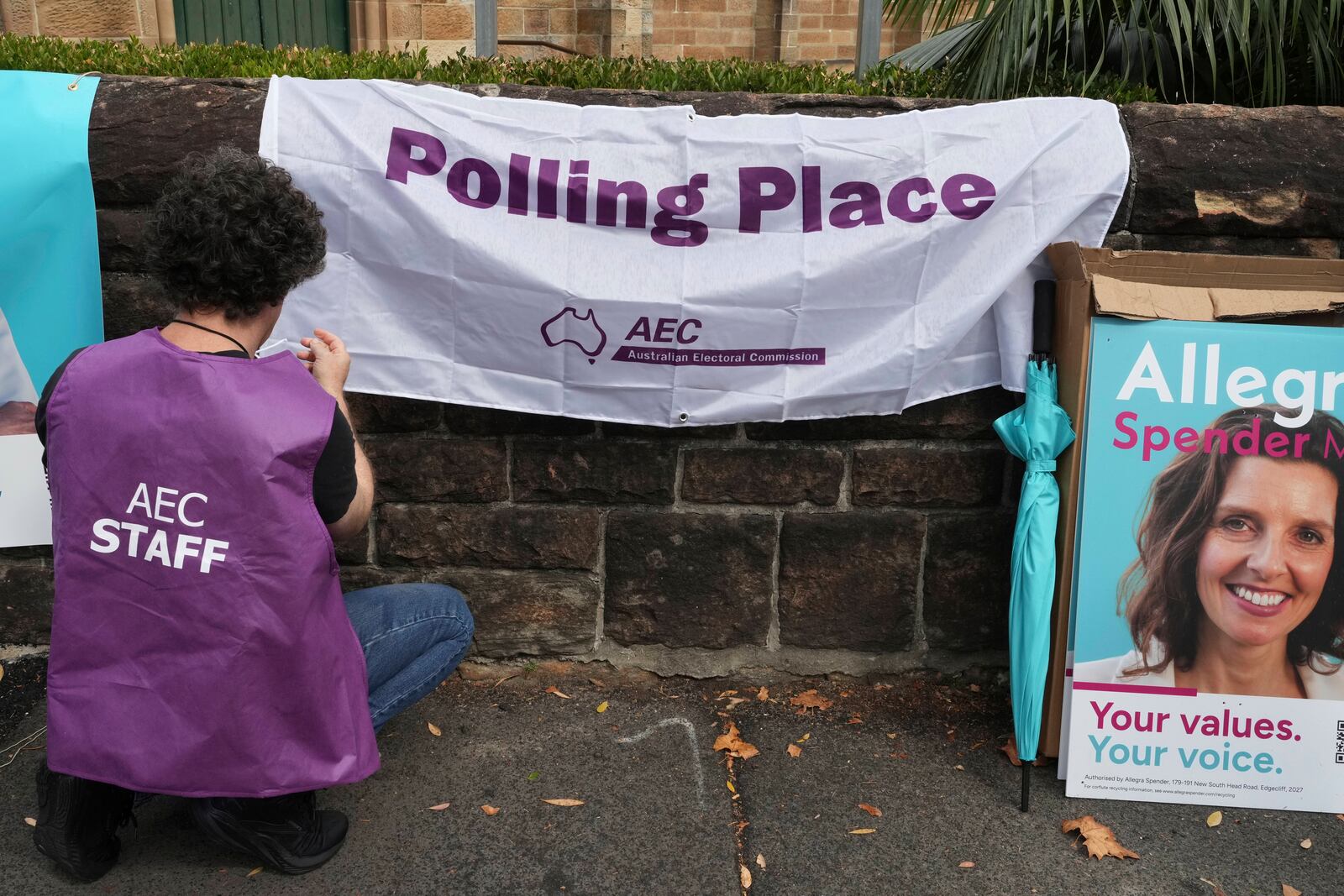An election official hangs a sign outside a polling place as early voting begins in Sydney, Tuesday, April 22, 2025, for a national election to be held on May 3. (AP Photo/Mark Baker)