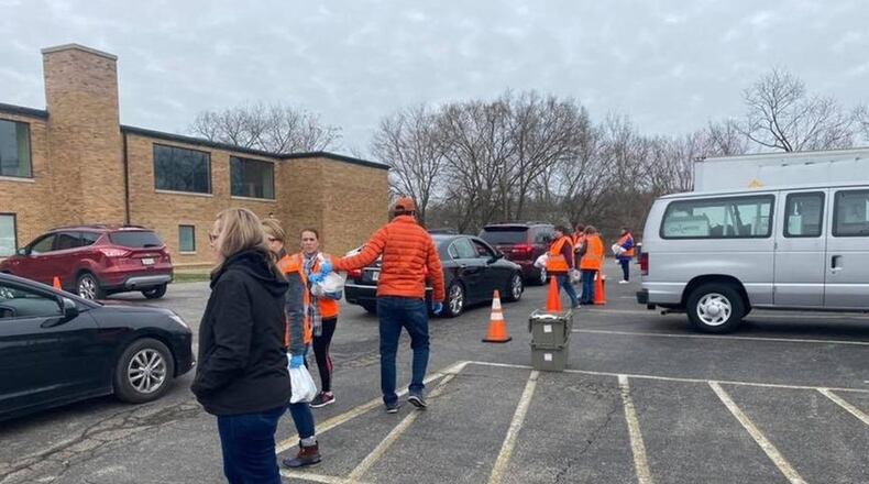 Kings Schools staffers and community volunteers started handing out free student meals to eligible students when state orders shut down all Ohio K-12 schools in March. Now many area school systems, including Kings, are continuing their free meal distributions during summer break for needy families whose children were eligible for federally funded, free and reduced meals during the school year. (Provided Photo/Journal-News)