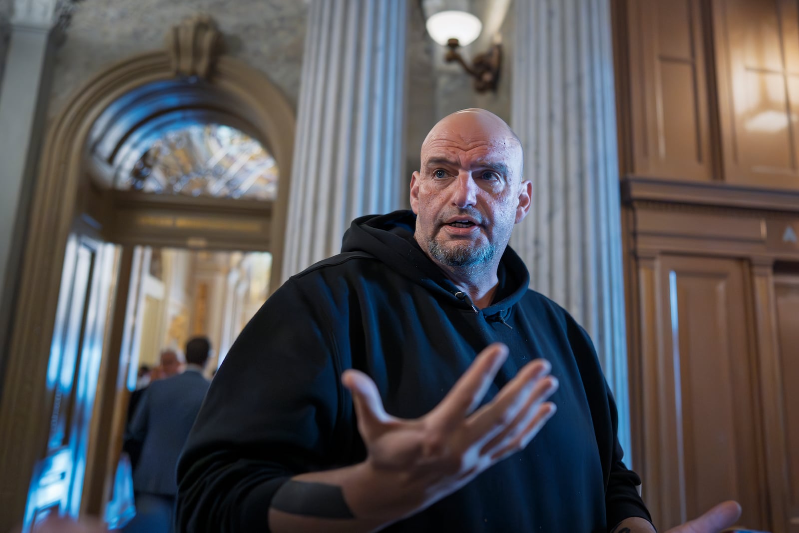 FILE - Sen. John Fetterman, D-Pa., talks to reporters outside the chamber during a vote at the Capitol in Washington, March 13, 2025. (AP Photo/J. Scott Applewhite, File)