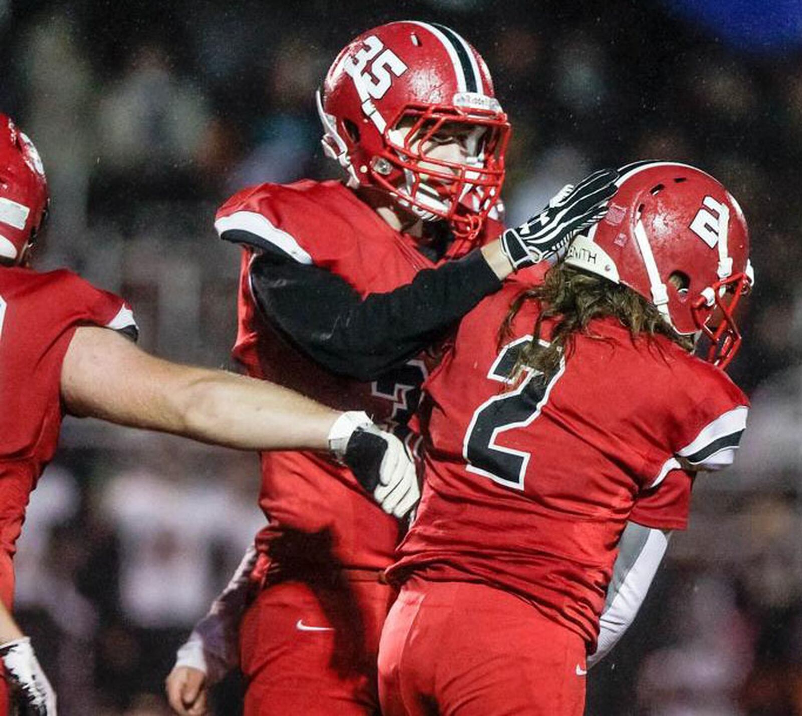 Madison’s Cameron Cooke (2) is congratulated by teammate Levi McMonigle (35) after making a play in an Oct. 26 game against Waynesville at Brandenburg Field in Madison Township. NICK GRAHAM/STAFF