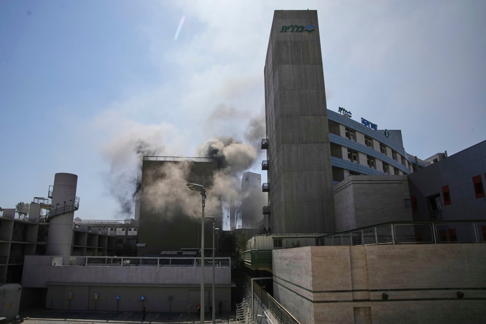 Smokes raises from a building of the Soroka hospital complex after it was hit by a missile fired from Iran in Be'er Sheva, Israel, Thursday, June 19, 2025. (AP Photo/Leo Correa)