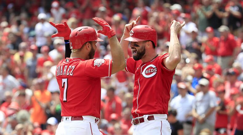 Eugenio Suarez (left) of the Cincinnati Reds celebrates with Jesse Winker after hitting a home run in the third inning against the Pittsburgh Pirates at Great American Ball Park on July 31, 2019 in Cincinnati. (Photo by Andy Lyons/Getty Images)