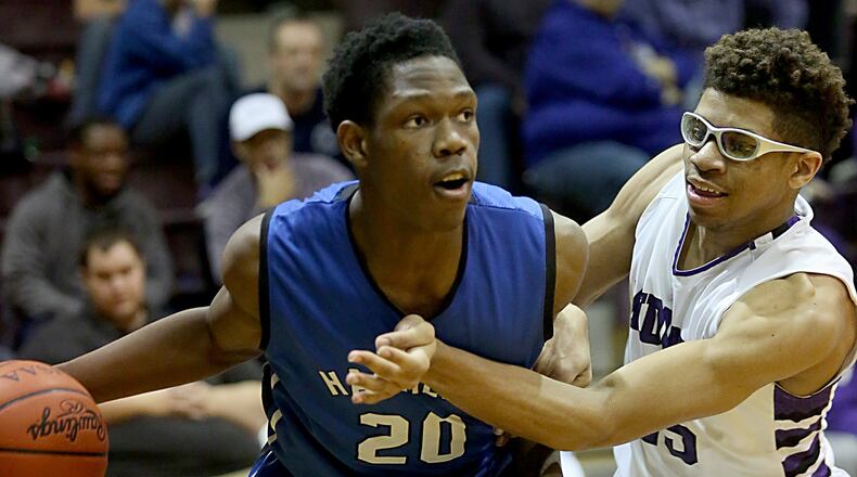 Hamilton’s Myles Howard drives on Middletown’s Jawunn Bailey during their game at Wade E. Miller Gym in Middletown on Jan. 13, 2017. COX MEDIA FILE PHOTO