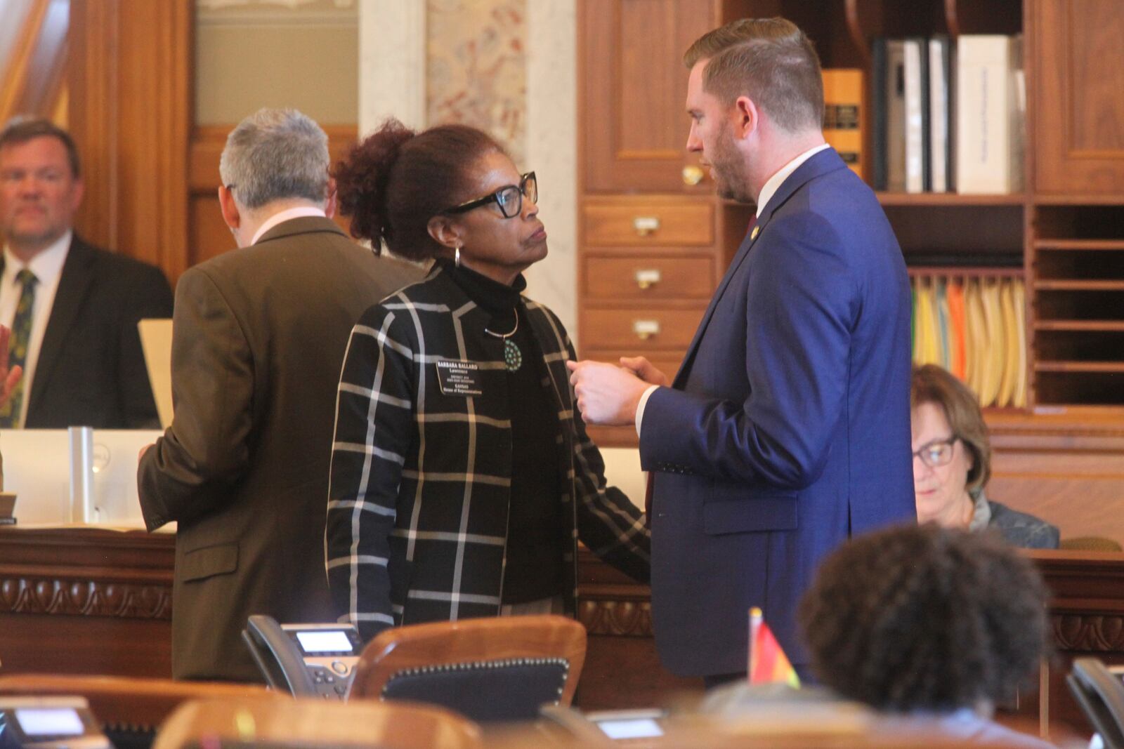Kansas state Rep. Barbara Ballard, left, D-Lawrence, and House Minority Leader Brandon Woodard, D-Lenexa, confer during a break in the House's debates over overriding Democratic Gov. Laura Kelly's vetoes, Thursday, April 10, 2025, at the Statehouse in Topeka, Ka (AP Photo/John Hanna) John