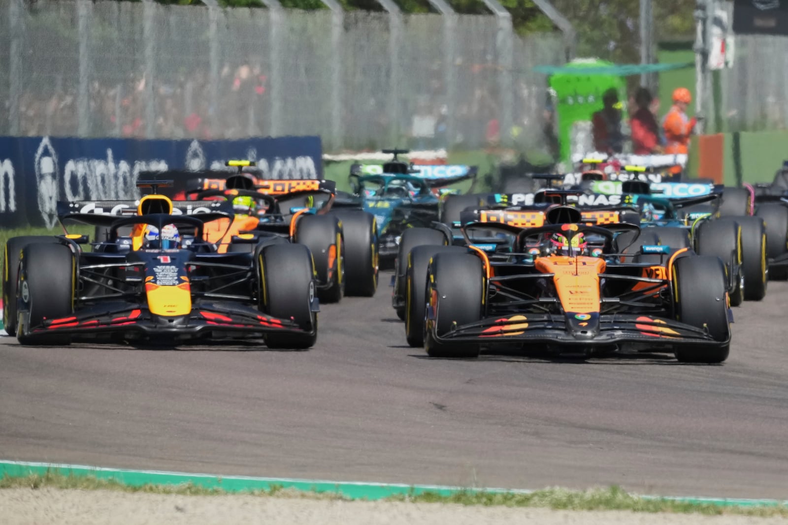 Red Bull driver Max Verstappen of the Netherlands, left, and McLaren driver Oscar Piastri of Australia leadat the start during the Italy's Emilia Romagna Formula One Grand Prix, in Imola, Italy, Sunday, May 18, 2025. (AP Photo/Antonio Calanni)