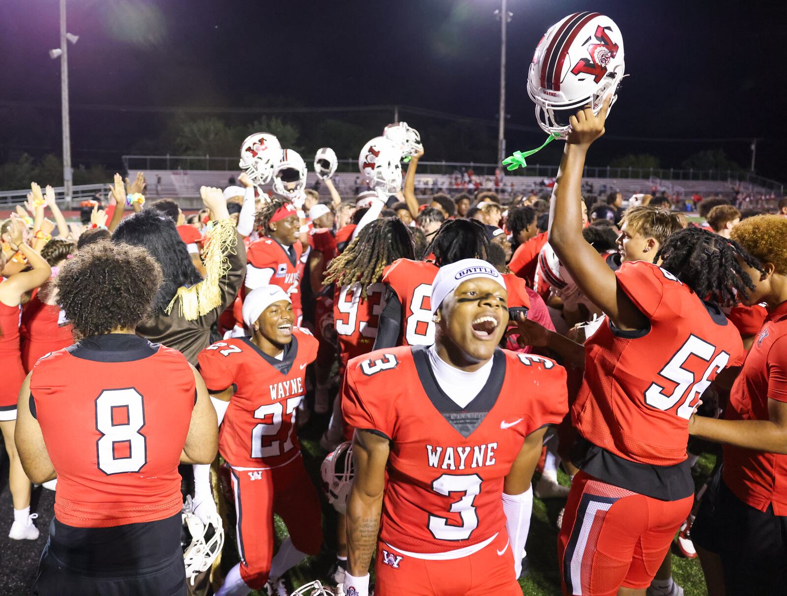 Wayne players celebrate after defeating Fairfield 31-24 in a season opener on Friday, Aug. 22 at Heidkamp Stadium in Huber Heights. The Warriors scored a late touchdown and held on to win. BRYANT BILLING / STAFF