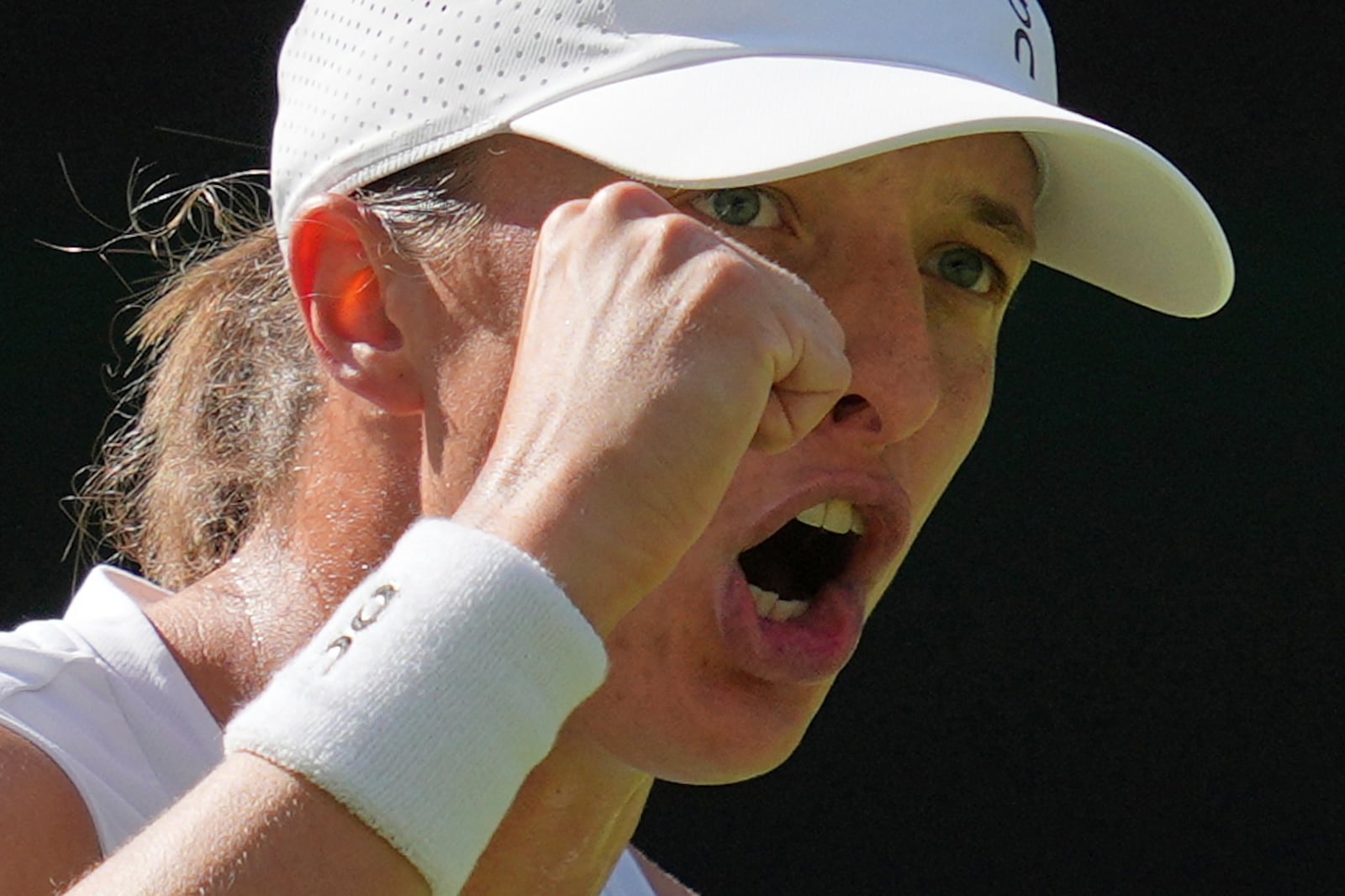 Poland's Iga Swiatek reacts as she wins a point against Switzerland's Belinda Bencic during a women's singles semifinal match at the Wimbledon Tennis Championships in London, Thursday, July 10, 2025. (AP Photo/Kin Cheung)