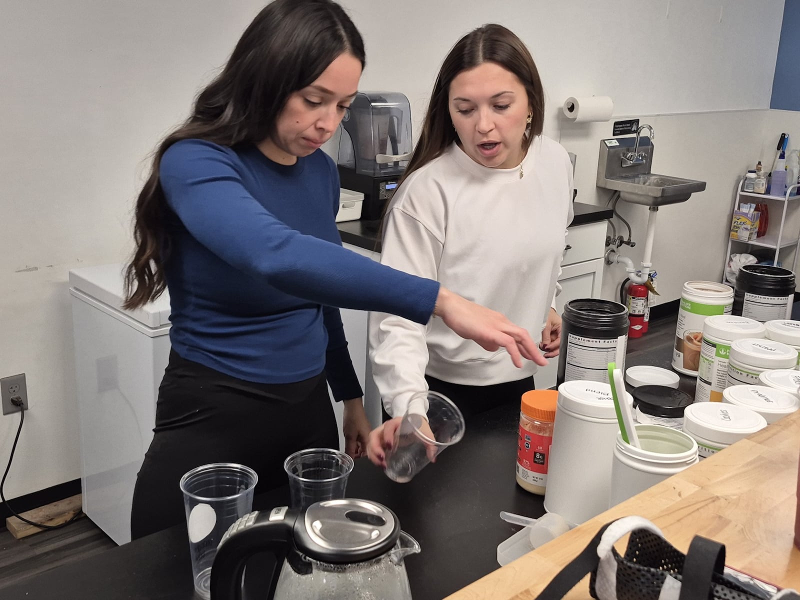 New owner Kelly Murray, left, and her business mentor Dominique Tussing prepare drinks for customers at the Jan. 2 grand reopening of Boro Blends, 760 W. Central Ave., in Springboro. MICHAEL KURTZ / STAFF