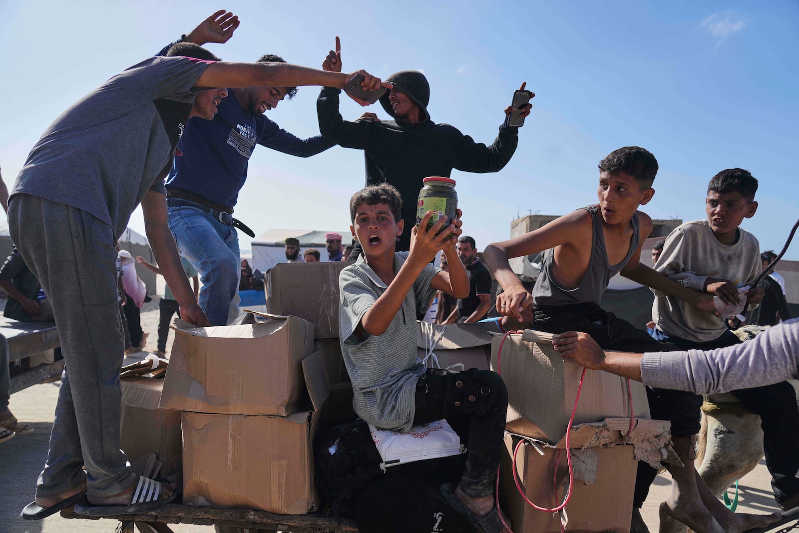 FILE - Palestinians carry boxes containing food and humanitarian aid packages delivered by the Gaza Humanitarian Foundation, a U.S.-backed organization approved by Israel, in Rafah, southern Gaza Strip, Tuesday, May 27, 2025. (AP Photo/Abdel Kareem Hana,File)