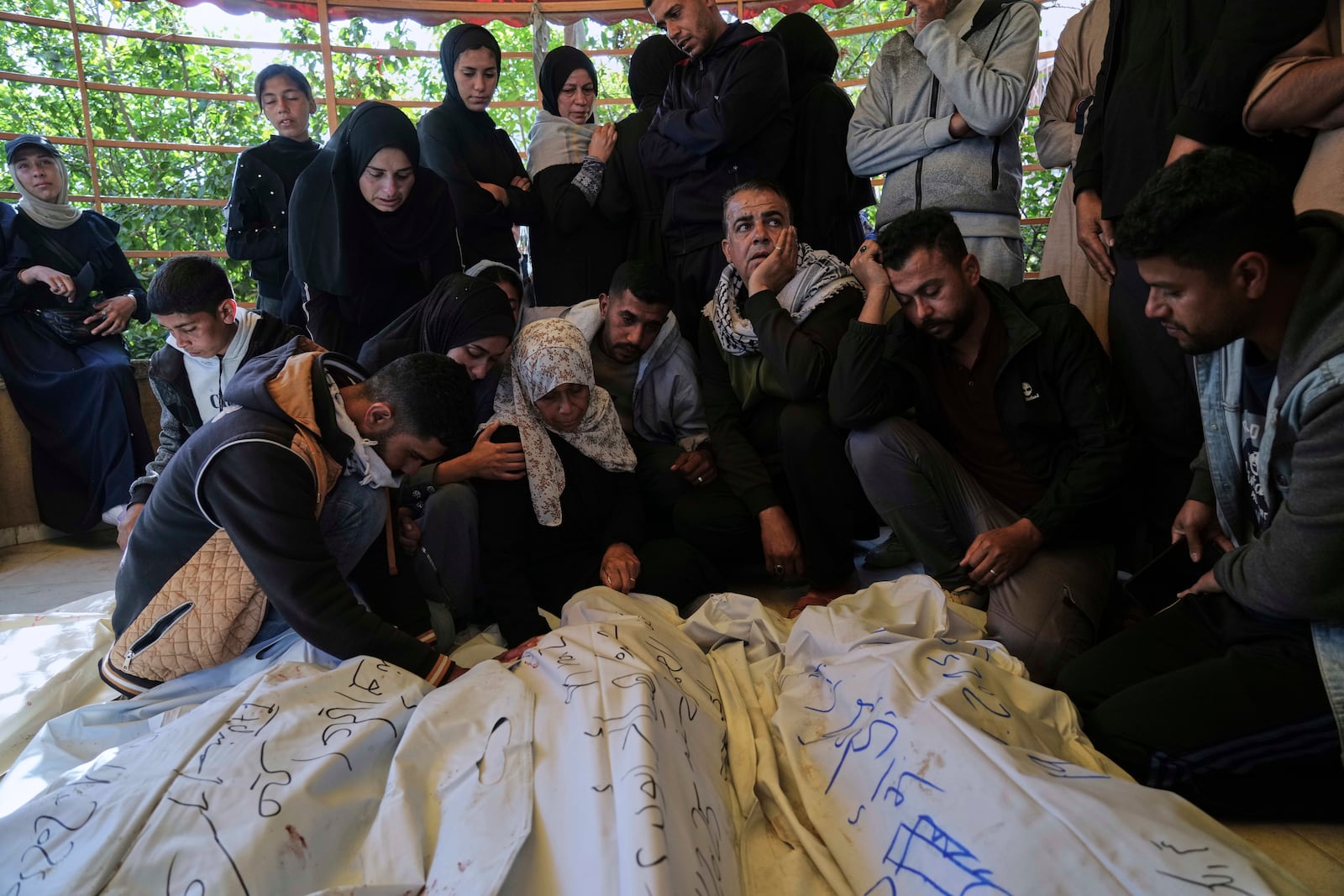 Palestinians mourn over the bodies of their relatives killed in an Israeli army airstrike, during their funeral in Khan Younis, southern Gaza Strip, Saturday, April 19, 2025. (AP Photo/Abdel Kareem Hana)