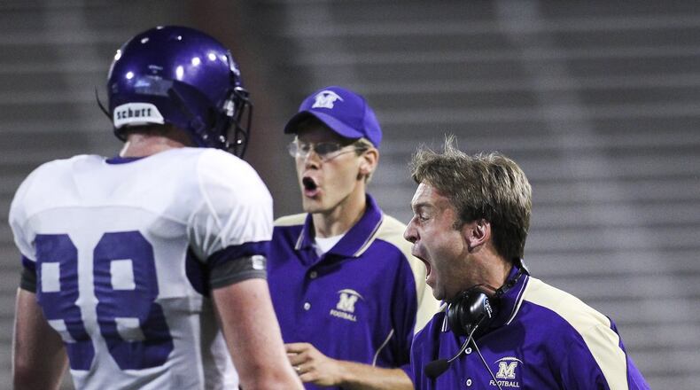 Middletown head football coach Troy Everhart (right) gets fired up during a Crosstown Showdown game against St. Xavier at the University of Cincinnati’s Nippert Stadium last season. Everhart feels good about the Middies with leaders such as Kevin Henry and Chance Sorrell (88). Staff photo by Nick Daggy