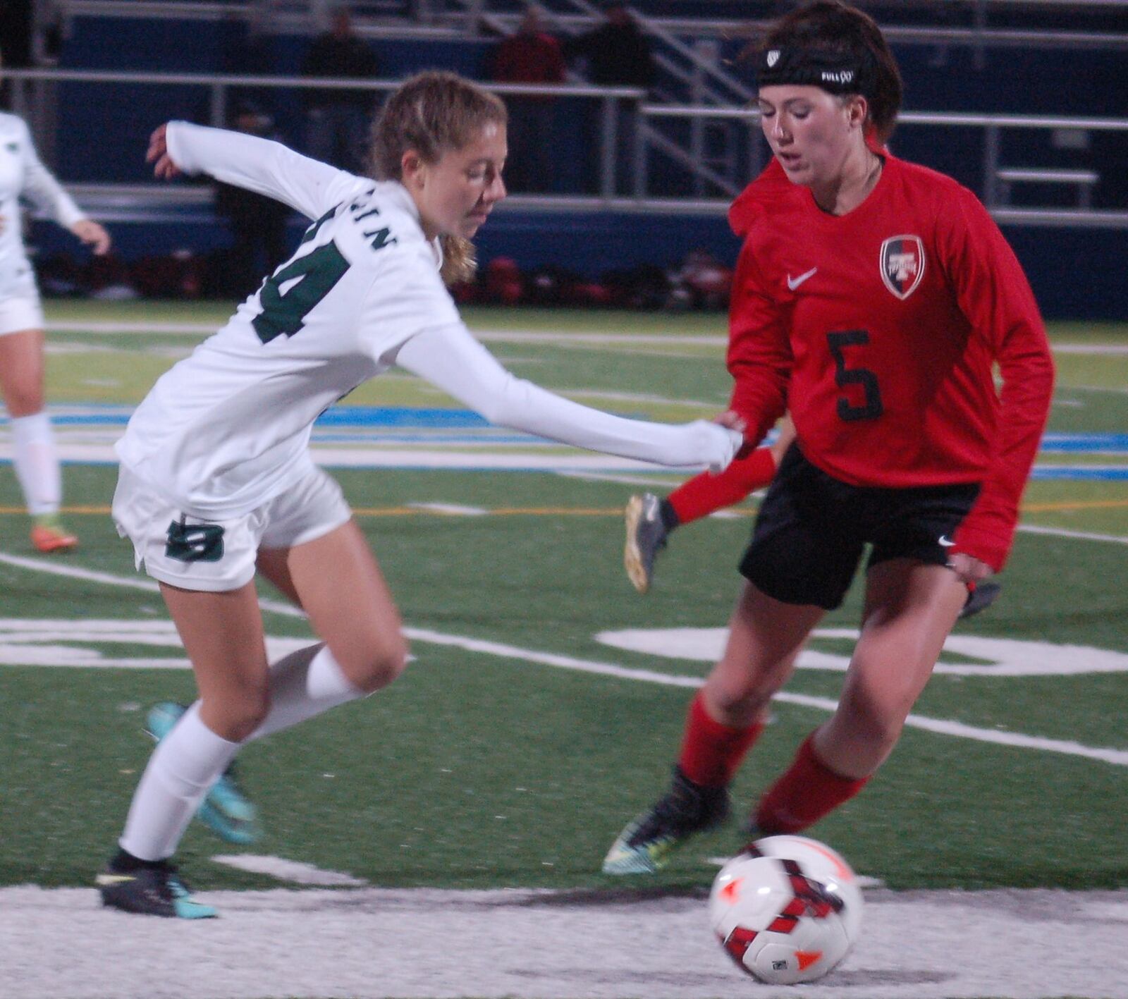 Badin’s Sophie Blasi makes a move on Tippecanoe’s Mackenzie Weaver (5) during Tuesday night’s Division II regional semifinal at Chaminade Julienne’s Roger Glass Stadium. Weaver’s Red Devils won 1-0. CONTRIBUTED PHOTO BY JOHN CUMMINGS