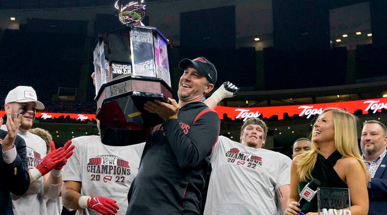 Western Kentucky coach Tyson Helton holds the trophy after the team's victory over South Alabama in the New Orleans Bowl NCAA football game in New Orleans, Wednesday, Dec. 21, 2022. (AP Photo/Matthew Hinton)