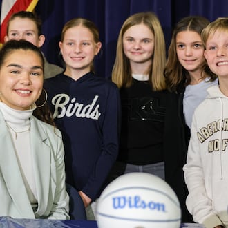 Maddy Westbeld (bottom left), a Fairmont graduate who plays professional basketball for Chicago Sky, poses for a photo with students after talking at an afternoon assembly at J.E. Prass Elementary School in Kettering on Friday, Dec. 12. BRYANT BILLING/STAFF