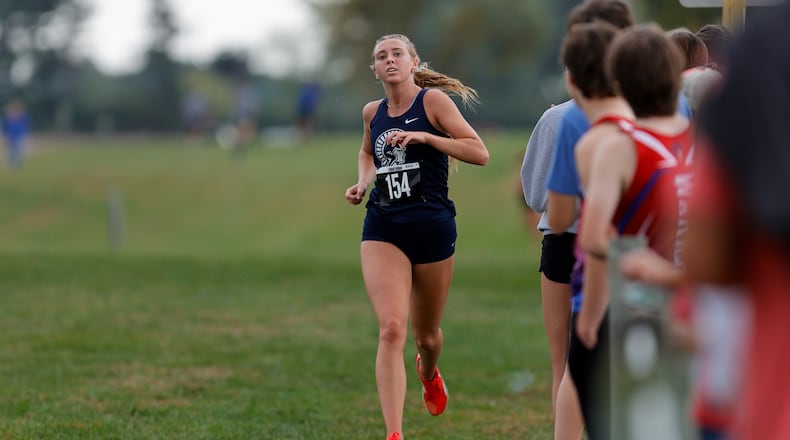 Valley View High School senior Addy Abner runs past a group of spectators during the Division III district cross country meet held Saturday, Oct. 18 at Cedarville University. Abner took first in a time of 19:01. MICHAEL COOPER / STAFF