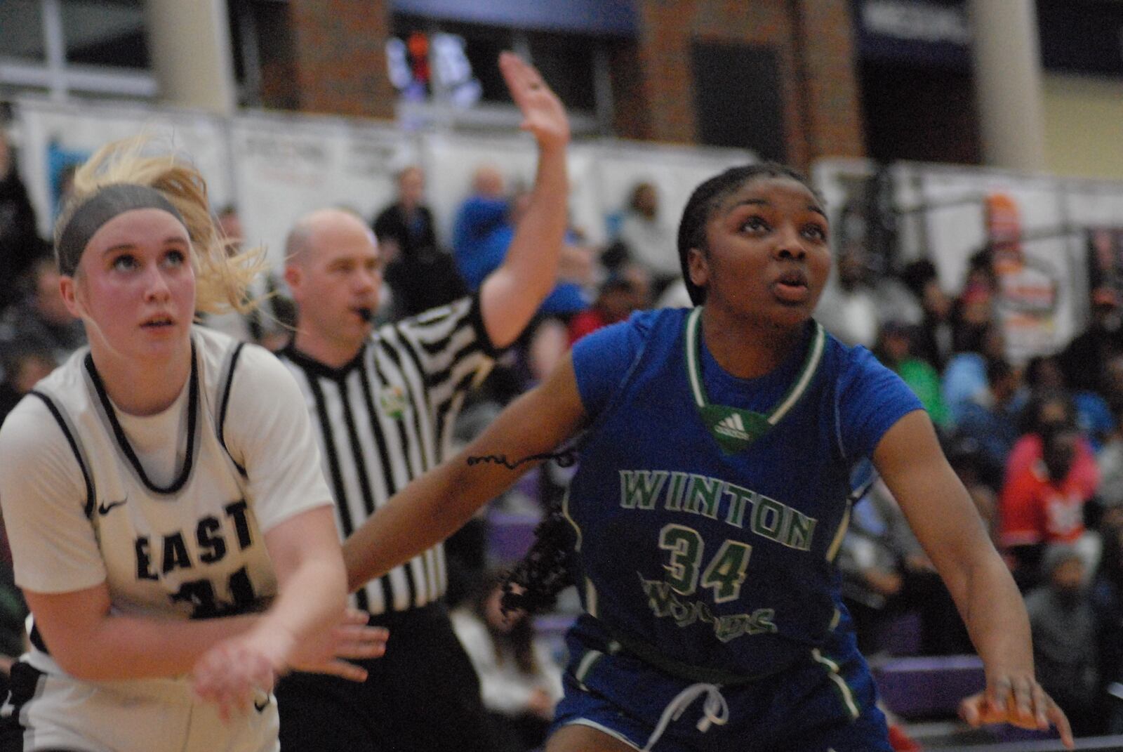 Lakota East's Brooke Asher and Winton Woods' Leigha Acoff fight for position during a free throw attempt on Tuesday night. Chris Vogt/CONTRIBUTED