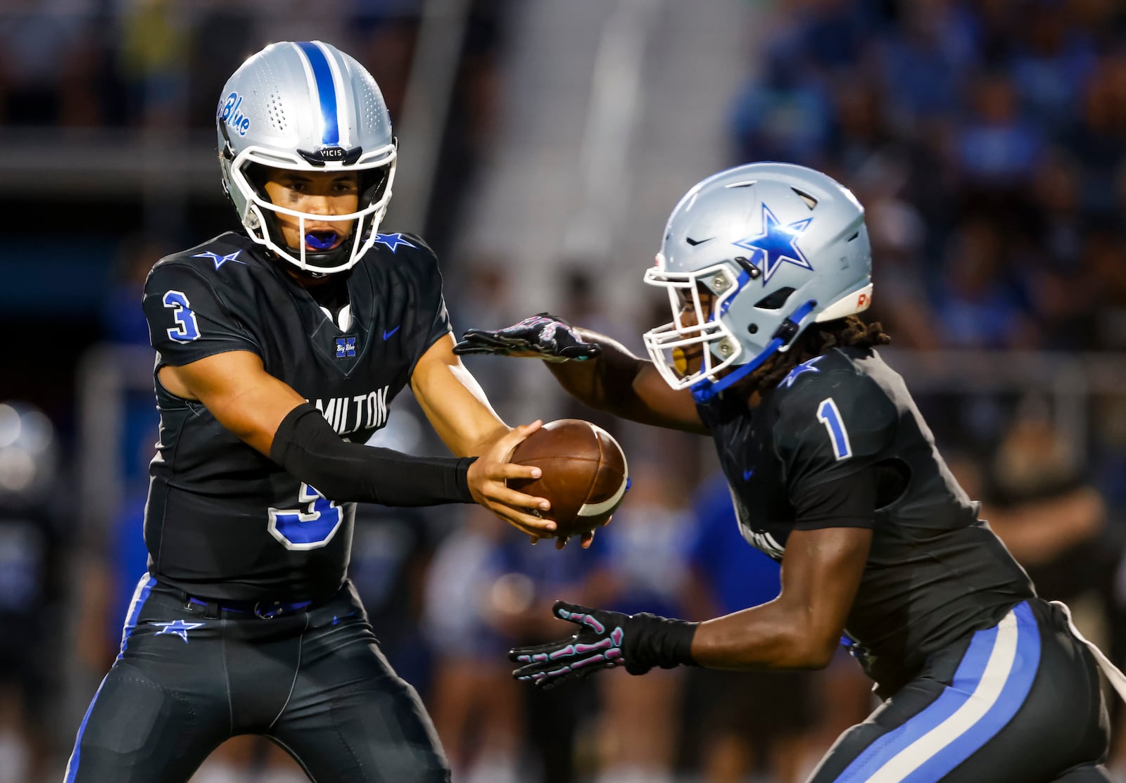 Hamilton's Jayden McClain fakes a handoff to Andre Bailey on week one of high school football against Badin Friday, Aug. 22, 2025 at Virgil M. Schwarm Stadium in Hamilton. Badin won 38-20. NICK GRAHAM/STAFF