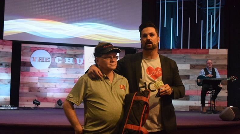 Curtus Moak (right), lead pastor at Hamilton Christian Center, surprised pizza delivery driver Kenny Sharp (left) with a tip in the amount of $3,000. Now, Moak is working on taking a group of athletes on a mission trip to Nicaragua.